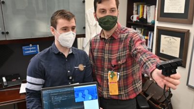 Joseph Sanford, M.D., and Adria Abella Villafranca use code they have written to test the OAK-D camera, equipped with spatial artificial intelligence.