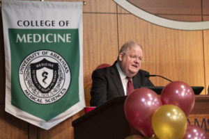 James Graham, executive associate dean of academic affairs for the College of Medicine, addresses the class of 2021 from the podium as the seniors watch via Zoom.