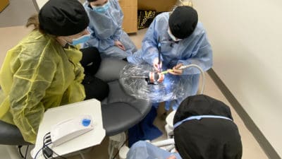 Students at the new UAMS Dental Hygiene Clinic hone their new skills on a practice model set of teeth.