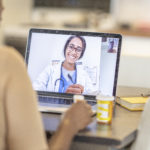 African American woman has medical consultation appointment video video call with her doctor.