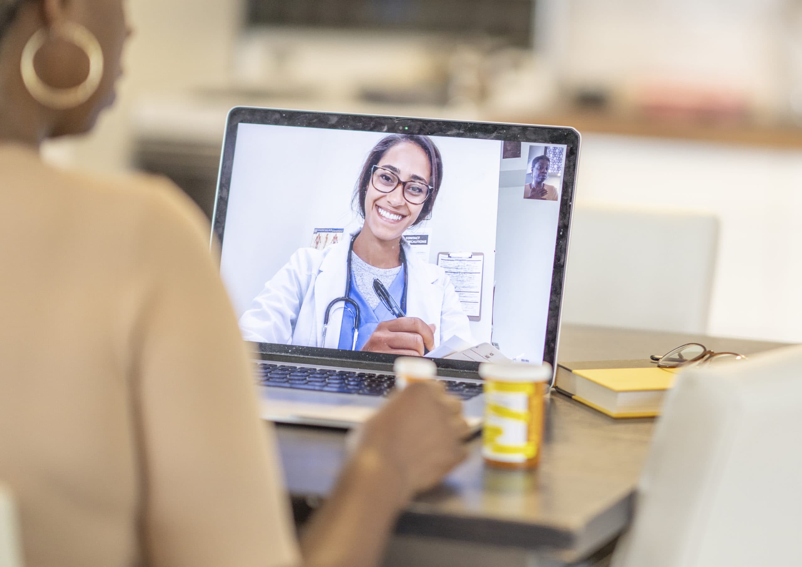African American woman has medical consultation appointment video video call with her doctor.