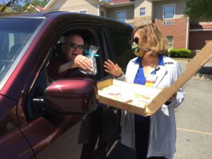 "I'm so ready to come back," volunteer Henry Noor told Susan Jones, assistant director of volunteer services and auxiliary as the chatted during the drive-thru. Noor, who volunteers distributing snacks to patients and their family members, is usually the giving the treats instead of receiving them.