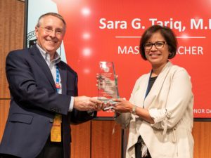 Robert Hopkins Jr., M.D., presents the Master Teacher Award to Sara Tariq, M.D., for her exemplary work with medical students and initiatives to help faculty colleagues become better teachers of future physicians.