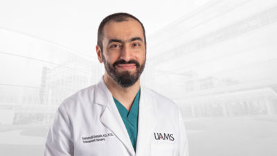 Emmanouil Giorgakis, M.D., in white coat.