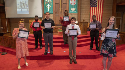 This year's Project SEARCH graduates hold their diplomas after the ceremony at St. Andrew's United Methodist Church in Little Rock. They are, left to right, Donna Pelle, Unard Bush, Marshall Neal, Jodarious Riggins, Matthew Henley Greenwalt, Joe Randall and Molly Stump.
