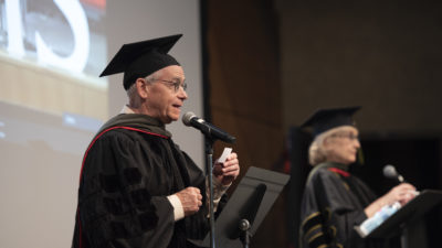 Eddie Dunn, Pharm.D., and Melanie Reinhardt, Pharm.D., announce graduates as they are hooded virtually by family and friends during the College of Pharmacy Seniors Honors & Awards Ceremony on May 14, 2021.