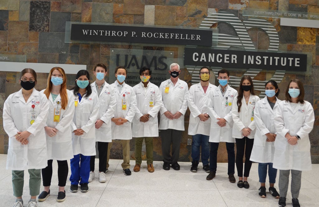 The NIH-funded Partners in Cancer Research Program is underway at the Winthrop P. Rockefeller Cancer Institute. Second-year medical students learning clinical and in-depth cancer research this summer include (l to r) Nadia Safar, Anna Bragg, Pamela Rosales, Payton Smith, Carl Ramponi, Faizan Cheema, Tom Kelly, M.D. (associate director of Cancer Research and Training), Angel Castro, Robert Kiss, Delanie Mack, Sangeetha Sonney and Claire Keisling. Matthew Newman is not pictured.