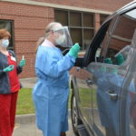 Ronald Brimberry, M.D., administers a COVID-19 test at a drive-thru testing site at the UAMS Northwest Regional Campus in Fayetteville.