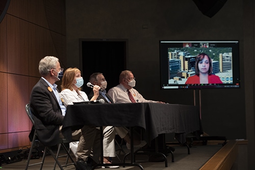 Michelle Krause, second from left, answers a question at the town hall. The other panelists were Steppe Mette, left, Krause, Robert Hopkins Jr., James Graham, and Danielle Lombard-Sims, on screen. 