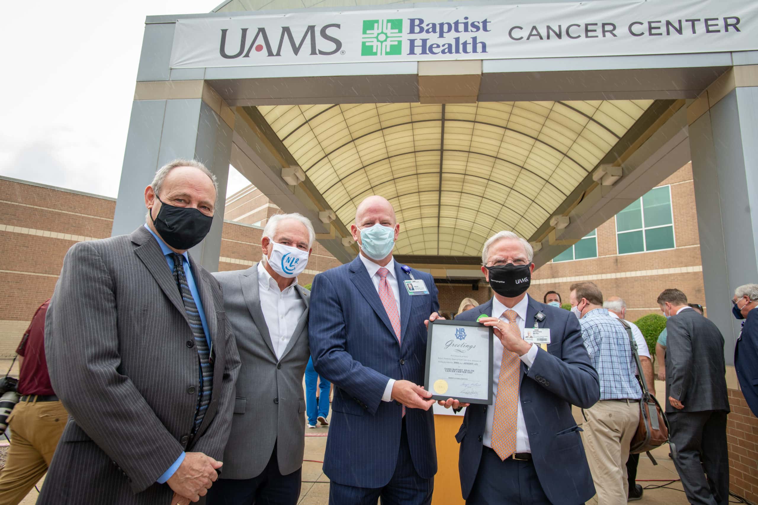 UAMS Winthrop P. Rockefeller Cancer Institute Director Michael Birrer, M.D., Ph.D., North Little Rock Mayor Terry Hartwick, Baptist Health CEO Troy Wells, and UAMS Senior Vice Chancellor and Medical Center CEO Steppe Mette, M.D., in front of the new UAMS Baptist Health Cancer Center in North Little Rock.