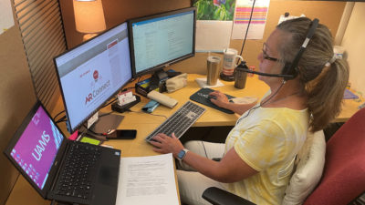 Administrative Coordinator Suzi Rook updates a schedule for AR-Connect’s therapists.