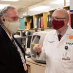 Terry Harville, M.D., Ph.D., consults with John Arthur, M.D., Ph.D., in the UAMS Pathology Lab.