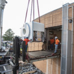 Using a crane, workers Sept. 13 install a new MRI scanner in the UAMS Psychiatric Research Institute.