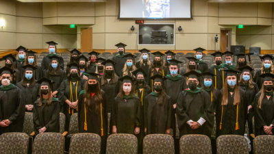 The Physician Assistant Program Class of 2021 stand Aug. 27 in Smith Auditorium for a final group photo after their Valediction ceremony.