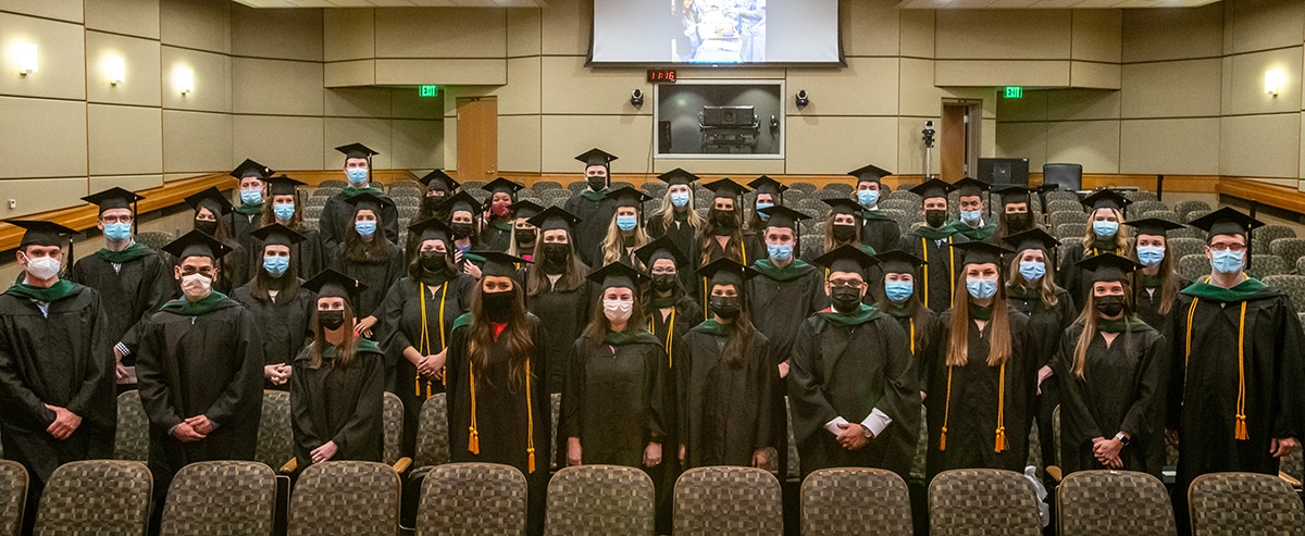 The Physician Assistant Program Class of 2021 stand Aug. 27 in Smith Auditorium for a final group photo after their Valediction ceremony.