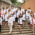 Students gather for a photo after receiving their white coats. They are members of the in the Master of Science (M.S.) in Communication Sciences in Disorders Class of 2023
