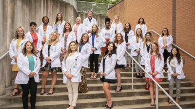 Students gather for a photo after receiving their white coats. They are members of the in the Master of Science (M.S.) in Communication Sciences in Disorders Class of 2023
