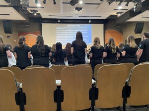 Nursing students stand in the auditorium to ecite the Nightingale Pledge 