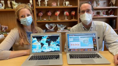Tiffany Huitt and Kevin Phelan sit behind open computers that display some of the NOAA curriculum students will use.