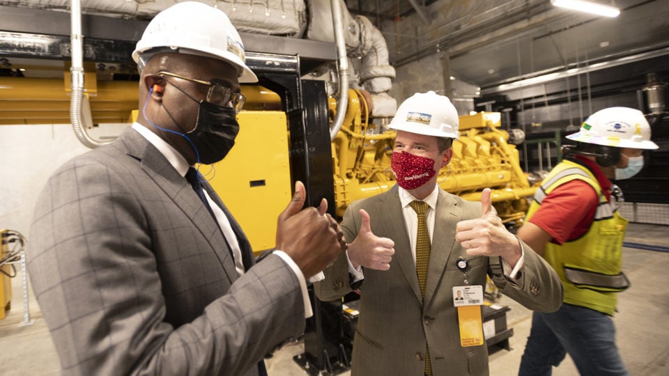 Chancellor Cam Patterson, right, shares a thumbs-up moment with Little Rock Mayor Frank Scott Jr. after the mayor turned on one of the generators in the new power plant at the conclusion of the formal opening of the facility.