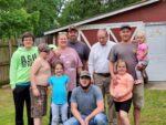 Mike Booker (white shirt) was diagnosed with frontotemporal dementia in 2010. He is shown with his daughter, son-in-law, son and grandchildren.