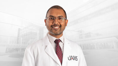 Harshad Ladha, M.D., in white coat