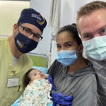 Larry Hartzell, M.D., and Jeff Dorrity, M.D., with one of their tiny cleft patients and her mother in Ecuador
