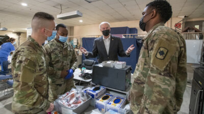 Gov. Asa Hutchinson talks with National Guard soldiers who have been deployed to UAMS to help with COVID-19 testing.