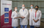 Pictured with the award, left to right: Erika Petersen, M.D., neurosurgeon; John Day, M.D., chair of the Department of Neurosurgery; Viktoras Palys, M.D., neurosurgeon; and Ebonye Green, APRN, Department of Neurosurgery. Not pictured: Analiz Rodriguez, M.D., neurosurgeon.