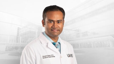Dinesh Edem, M.D., in white coat