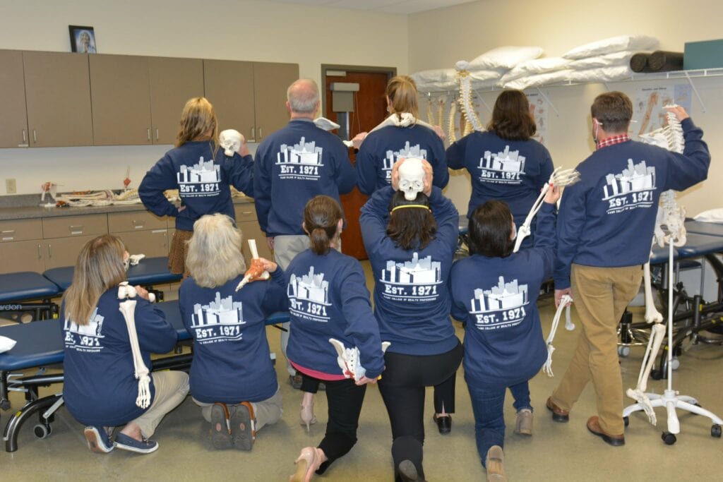 Faculty and state of the Department of Physical Therapy show the backs of the sweatshirts.