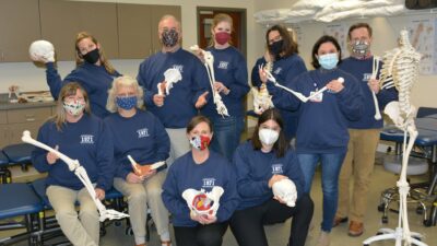 During a week of celebrations in late November and early December, faculty and staff of the College's Department of Physical Therapy show off their 50th anniversary sweatshirts.