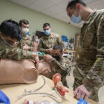 Members of the 189th Medical Group train in trauma care with manikin in the UAMS Simulation Center.