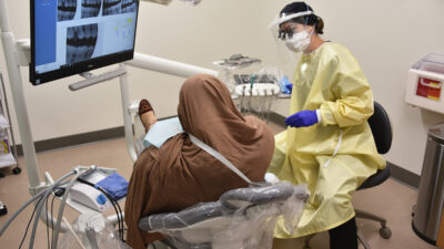 An Afghan refugee woman receives a dental assessment at the UAMS Dental Hygiene Clinic.