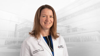 Julie Riley, M.D., in white coat
