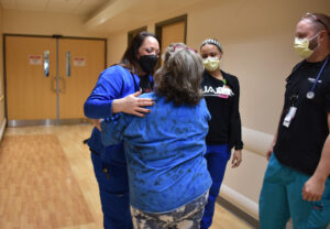 Sherri Holder hugs one of the nurses who cared for her as she battled COVID-19 last year.