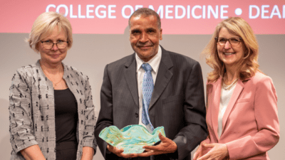 Billy Thomas, M.D., MPH, a professor of pediatrics, (center) is the UAMS College of Medicine’s 2022 Distinguished Faculty Service Award recipient. He is joined on stage by his nominator, Renee Bornemeier, M.D., (left) and Susan Smyth, M.D., Ph.D., executive vice chancellor and dean.