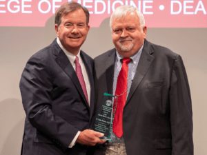 Orthopaedic Surgery Chair C. Lowry Barnes, M.D., presents the Master Teacher Award to R. Dale Blasier, M.D. (right).