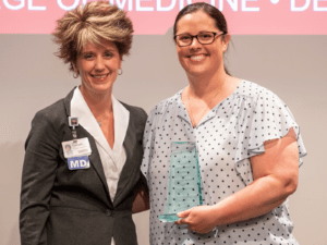 Molly Gathright, M.D., vice dean for graduate medical education, presents the Residency Educator Program Director Award to Mary Katherine Kimbrough, M.D. (right).