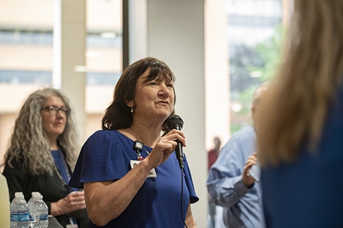 UAMS Provost Stephanie Gardner delivers some brief public remarks at the start of the College of Health Professions brunch reception for graduates and their friends and family.
