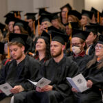 College of Nursing graduates take part in the hooding and pinning ceremony.