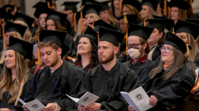 College of Nursing graduates take part in the hooding and pinning ceremony.