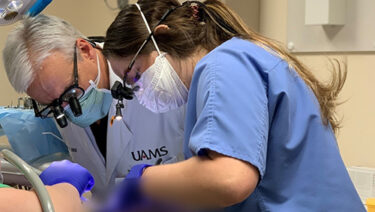 Nakita Riley, right, treats a patient with the assistance and supervision of Lee Hinson, D.D.S.