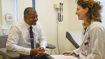 Nathaniel Noble, an ARresearch volunteer, discusses a study with UAMS' Giuseppina “Giusy” Dusio, Ph.D., in this file photo.