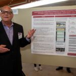 Ronald Thompson Jr., Ph.D., presents a poster on the study of a game app that aims to prevent prescription opioid misuse among adolescents.