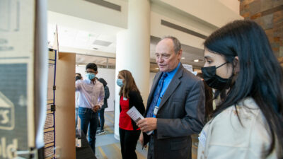 Cancer Institute Director Michael Birrer and a student