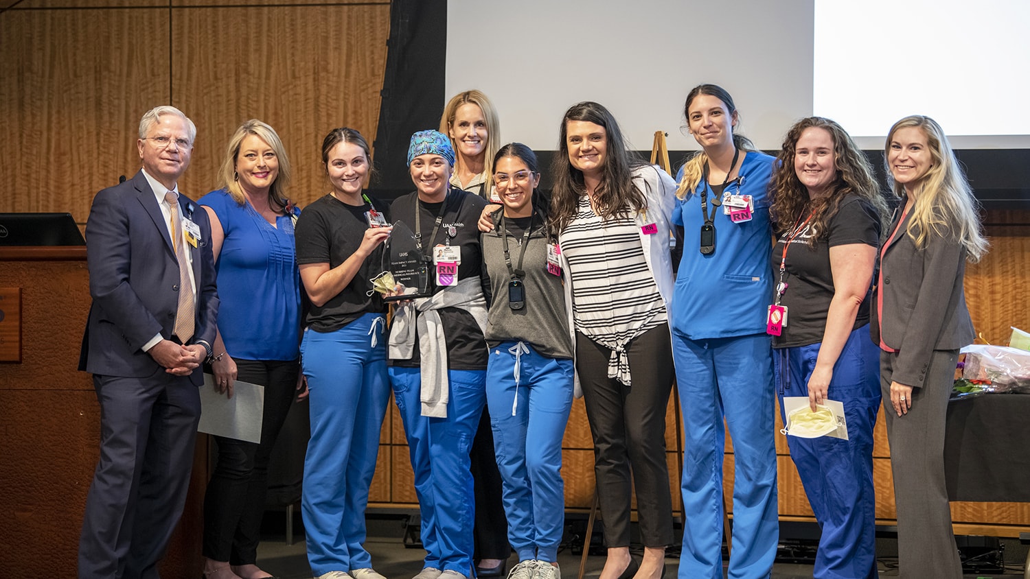 Steppe Mette, M.D., far left, presented the Team Impact Award to the E4 Intensive Care Unit nursing team, for their work caring for patients during the COVID-19 pandemic.