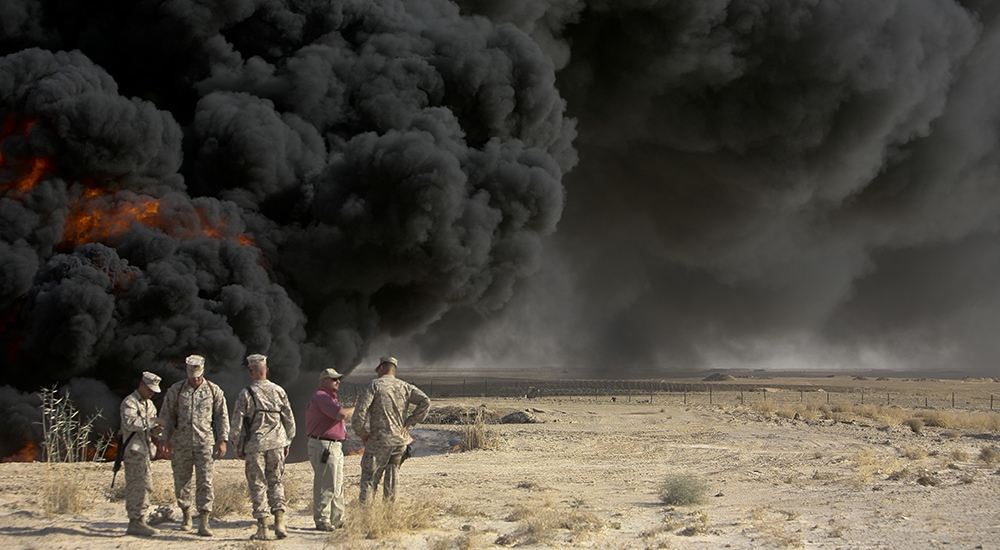U.S. Marines with 1st Marine Logistics Group view burn pit at Al Taqaddum Air Base, Iraq, Sept. 22, 2008.