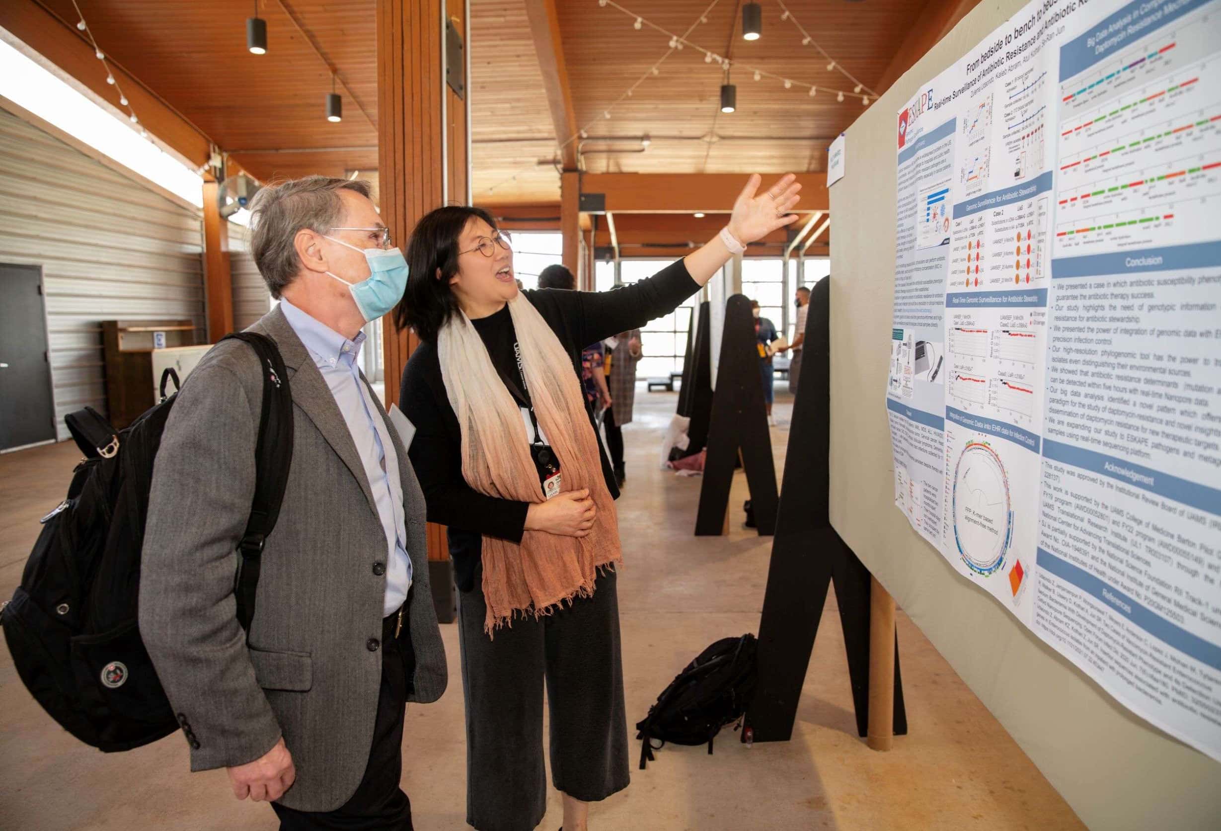 Se-Ran Jun, Ph.D., discusses her TRI pilot award-supported findings with Fred Prior, Ph.D., distinguished professor and chair of the Department of Biomedical Informatics, at TRI Research Day in April.