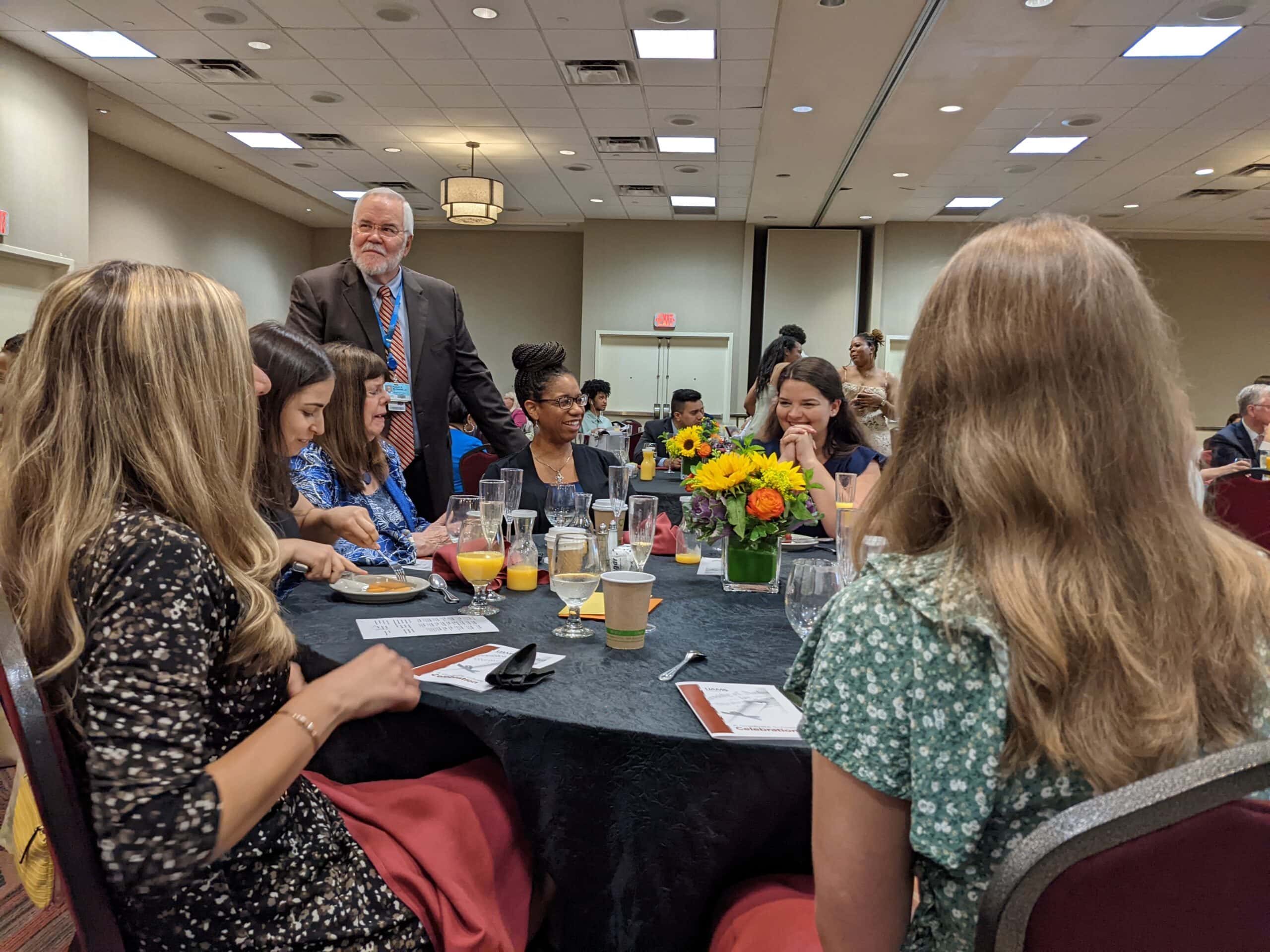 Robert McGehee, Ph.D., dean of the Graduate School, visits with the Class of 2022 during their Commencement Day brunch the morning of graduation.